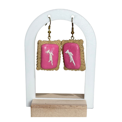 Pair of earrings with pink backs on a white stand